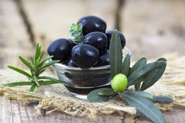 black olives and herbs in a bowl