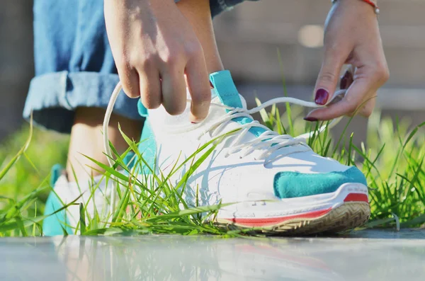 Young Girl Wearing Jeans Tying Shoelaces Sneakers Standing Green Grass — Stock Photo, Image