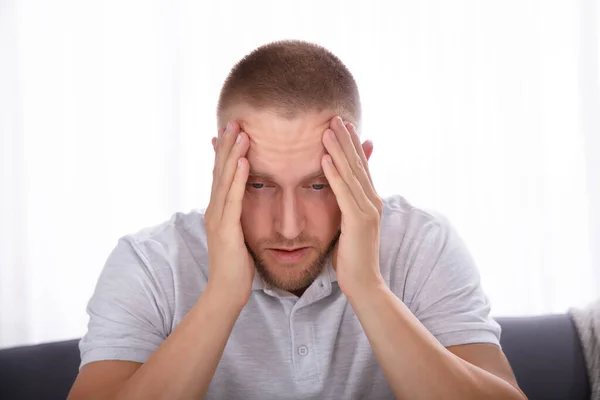 Side View Upset Young Man Sitting Sofa — Stock Photo, Image