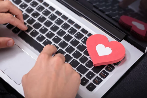 Person Hand Typing Laptop Keypad Red Heart — стоковое фото