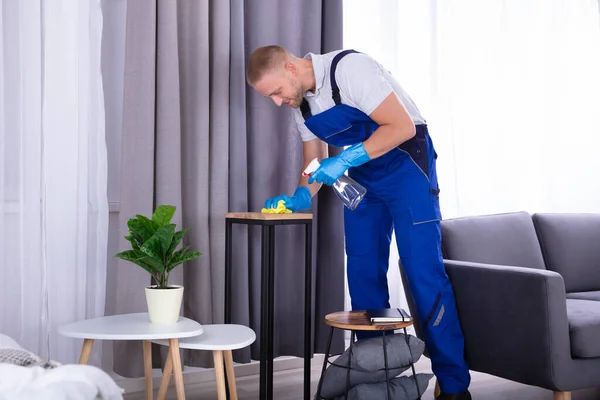 Joven Conserje Masculino Limpiando Muebles Madera Casa —  Fotos de Stock