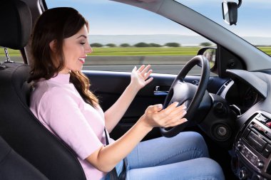 Side View Of A Happy Young Woman Sitting Inside Self Driving Car clipart