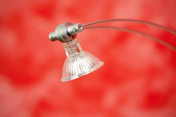red and white electric lamp on a green background