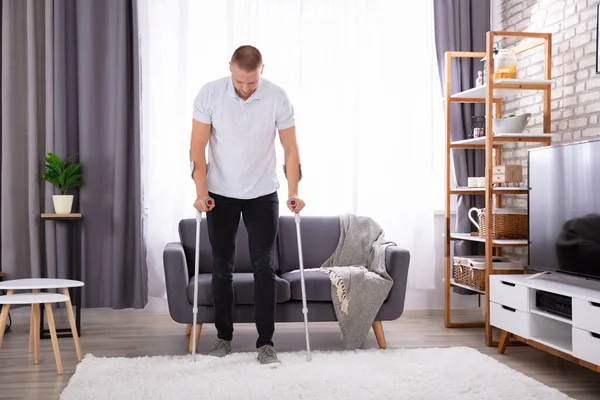 Disabled Young Man Using Crutches Walk Carpet — Stock Photo, Image