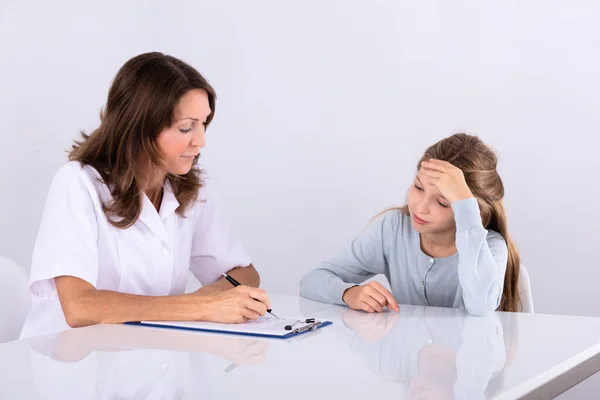 Female Doctor Clipboard Looking Depressed Girl Patient Clinic Royalty Free Stock Photos