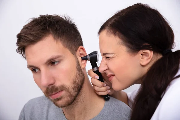 Female Doctor Examining Male Patient Ear Otoscope — Stock Photo, Image