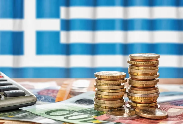 希腊国旗前的欧元钞票和硬币 — 图库照片