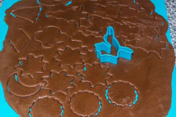 Raw Dough Being Punched Out Holiday Cookies Blue Underlay Preparing — Stock Photo, Image