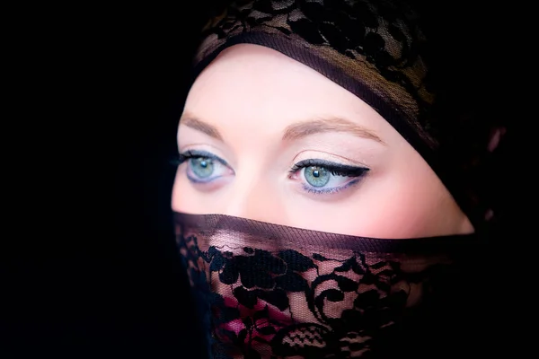 Veiled woman with blue eyes
