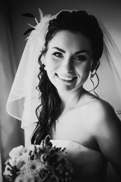 黒い白い写真美しい若い幸せな花嫁が窓の近くに立っている — ストック写真
