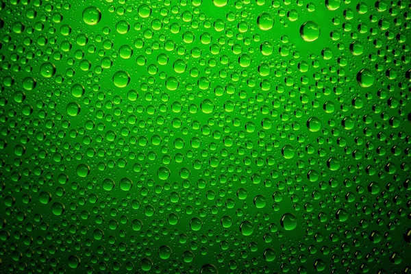 Green water drops background close up.