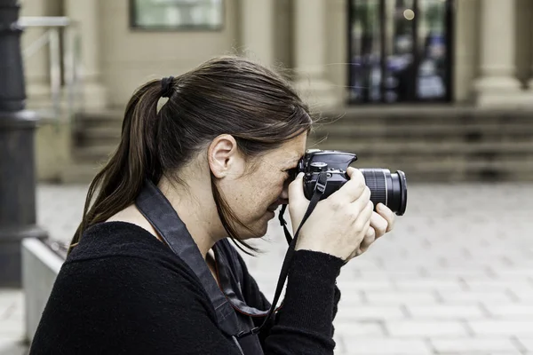 Woman photographer, detail of a young woman doing photographs