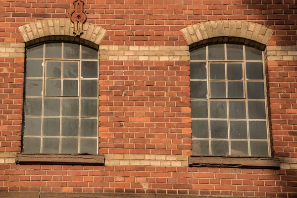 Old empty brick house factory with dark windows