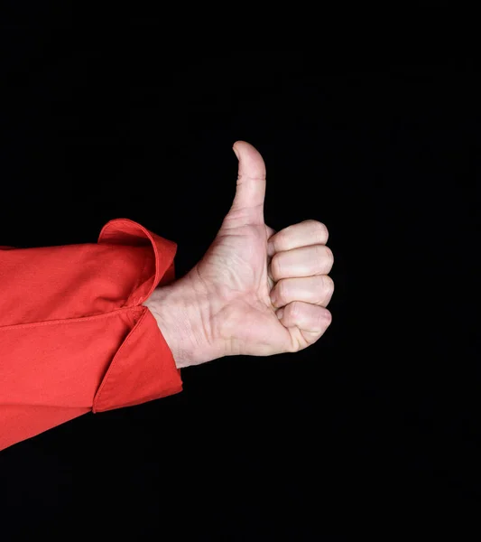 男性シェフの手の赤いユニフォームで黒の背景のような承認のジェスチャーを示しています — ストック写真