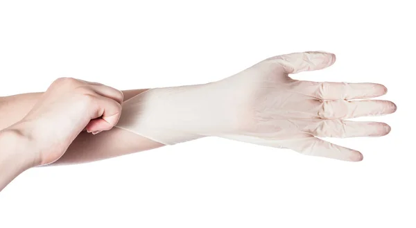 女性の手の上から見る白い背景に分離されて別の手のラテックス手袋を引っ張る — ストック写真