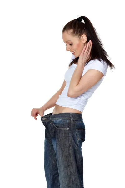 Mooie Jonge Vrouw Oude Jeans Het Afvallen Een Witte Achtergrond — Stockfoto