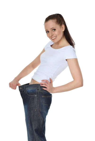 Mooie Jonge Vrouw Oude Jeans Het Afvallen Een Witte Achtergrond — Stockfoto