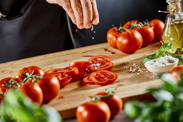 Mano Chef Sazonando Tomates Rodajas Una Tabla Cortar Madera Una — Foto de Stock