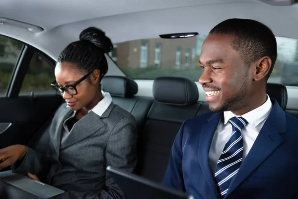 Two Happy African Businesspeople Using Electronic Devices While Traveling Car — Stock Photo, Image