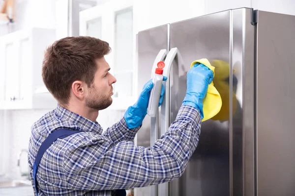 Zijaanzicht Van Jonge Man Schoonmaken Koelkast Met Servet Fles — Stockfoto