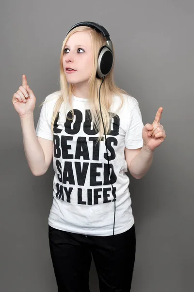 young woman with headphones and printed t-shirt