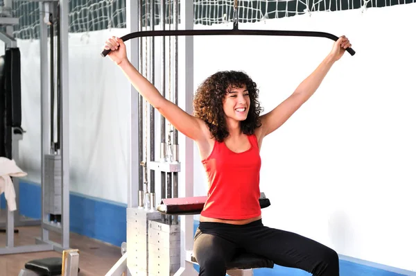 stock image young woman practicing fitness and working out in a gym