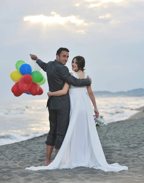 刚刚结婚的年轻夫妇欢庆美丽的海滩日落 玩得很开心 — 图库照片