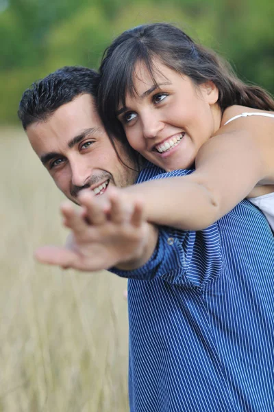 Happy Young Couple Have Romantic Time Outdoor While Smiling Hug Stock Photo