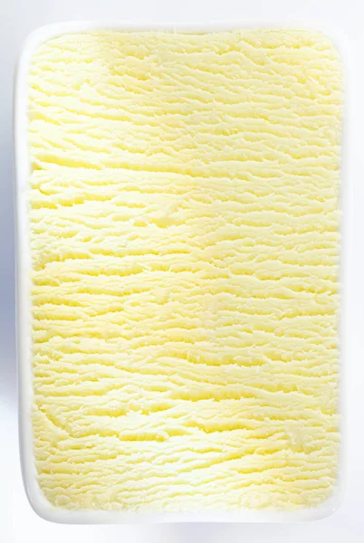 浓密的柠檬或香草冰淇淋桶的垂直背景纹理 中心有阴影的波纹 — 图库照片