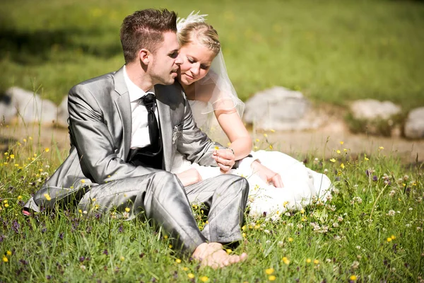 bride and groom with wedding dress and suit in nature