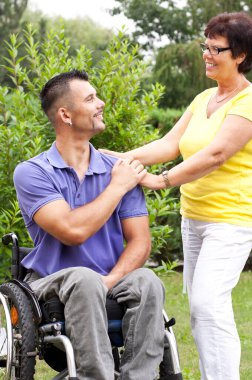 disabled man and woman in wheelchair with his wife clipart