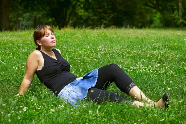 Eine Junge Frau Sitzt Auf Einer Grünen Wiese Der Sonne — Stockfoto