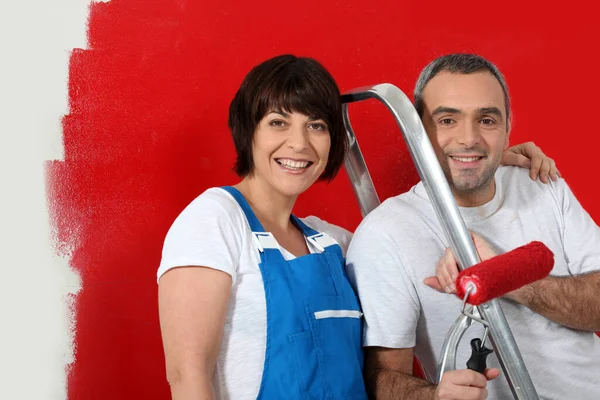 Couple Painting Wall Red Stock Image