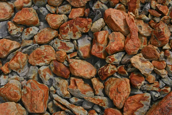 stones with orange coating in the geothermal area krysuvik - iceland