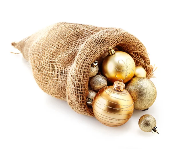 Ποικιλία Από Διακοσμητικά Χρυσά Χριστουγεννιάτικα Μπιχλιμπίδια Μια Τσάντα Hessian Ξεχειλίζει — Φωτογραφία Αρχείου