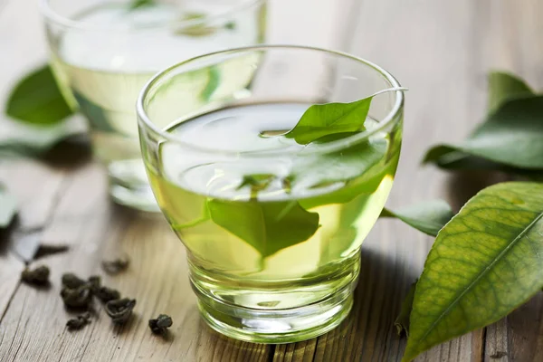 glass cup with fresh green tea