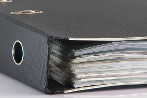 detail from stack of three black business folders on white