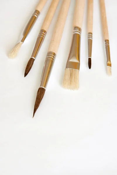 brushes and paint brush on white background