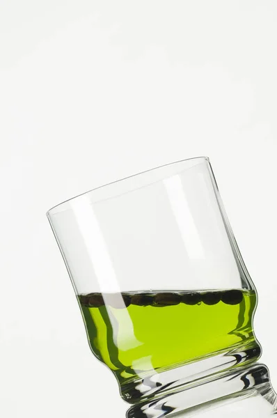 Studio Shot Van Een Schuin Glas Met Groene Vloeistof Voor — Stockfoto