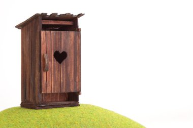 wooden house with a heart on a white background clipart