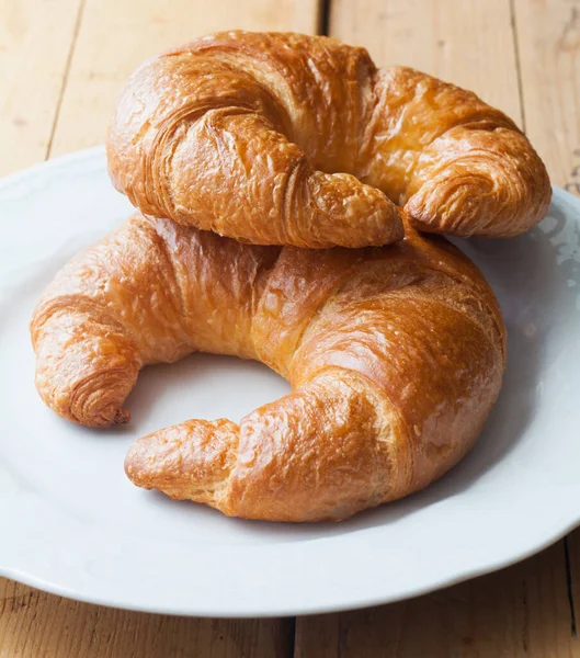 Continental Breakfast Two Fresh Croissants Resting White Plate Wooden Table — Stock Photo, Image
