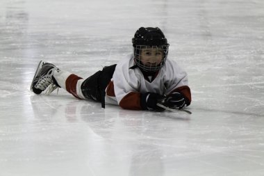 Child playing ice hockey clipart