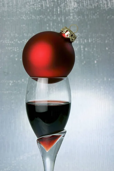 port wine glass with red christmas ball