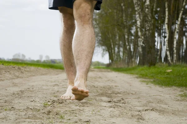 Close Male Unclothed Legs While Running Sand Path — Stock Photo, Image