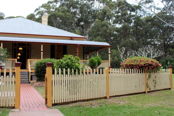 Historic colonial Australian house with garden and picket fence