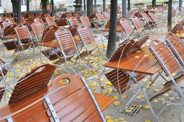 empty chairs and tables in the city of amsterdam, netherlands clipart