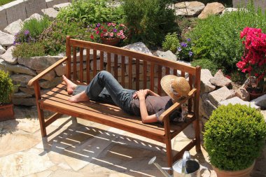 relaxing on a garden bench clipart