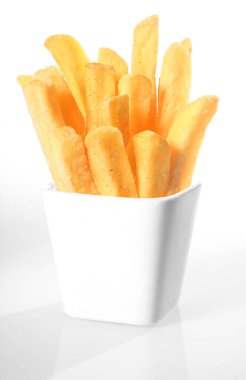 White ceramic container of crispy French fries or deep fried potato batons or chips on a white background clipart
