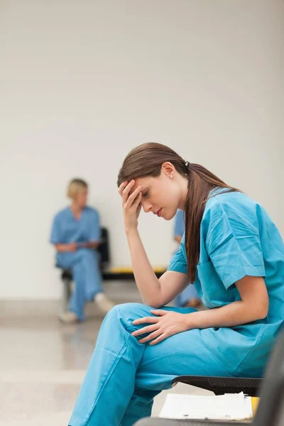 Sad Nurse Clipboard While Sitting Waiting Room Hospital — Stock Photo, Image