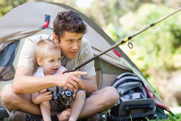 Father and son catching fish together